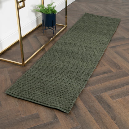 green knitted runner rug